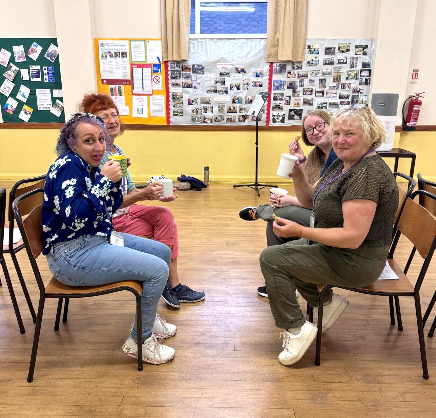 A photo of chorus members enjoying cups of tea and cookies