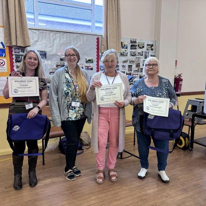 New members of More Harmony showing off their certificates upon joining